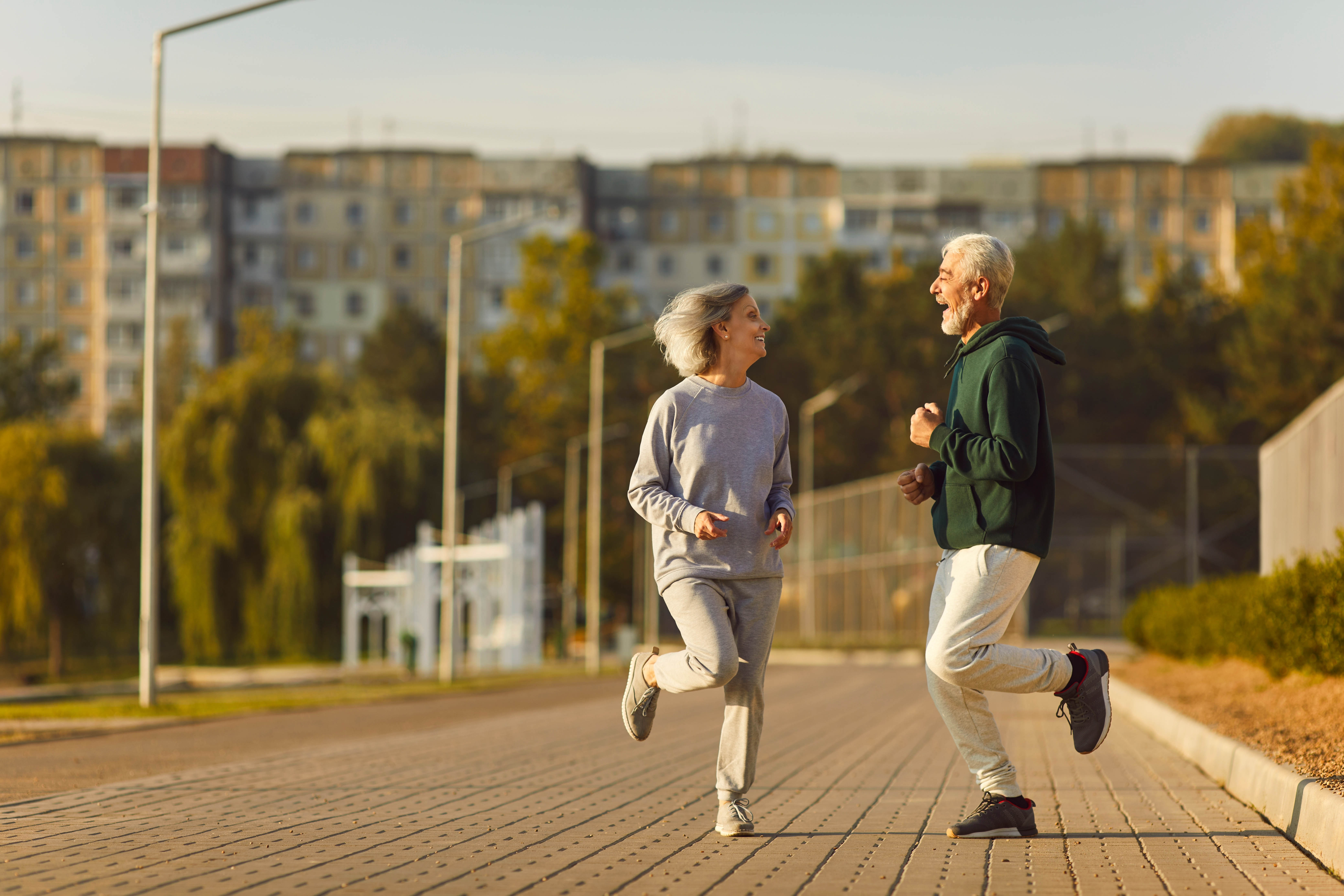 Older couple outside jogging on the spot Older couple outside jogging on the spot
